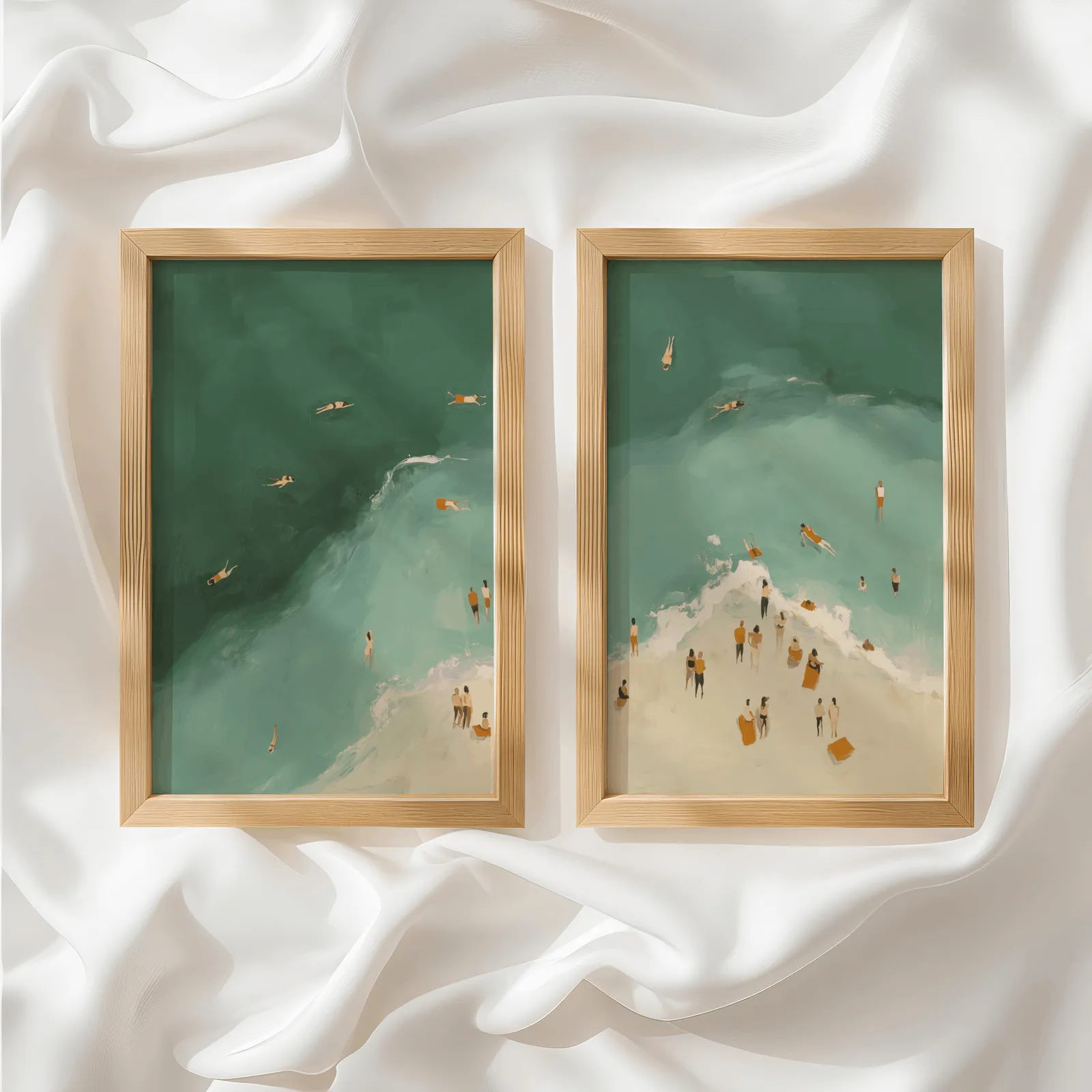 green coastal beach wall art set of two with swimmers, side by side atop rumpled white silky fabric